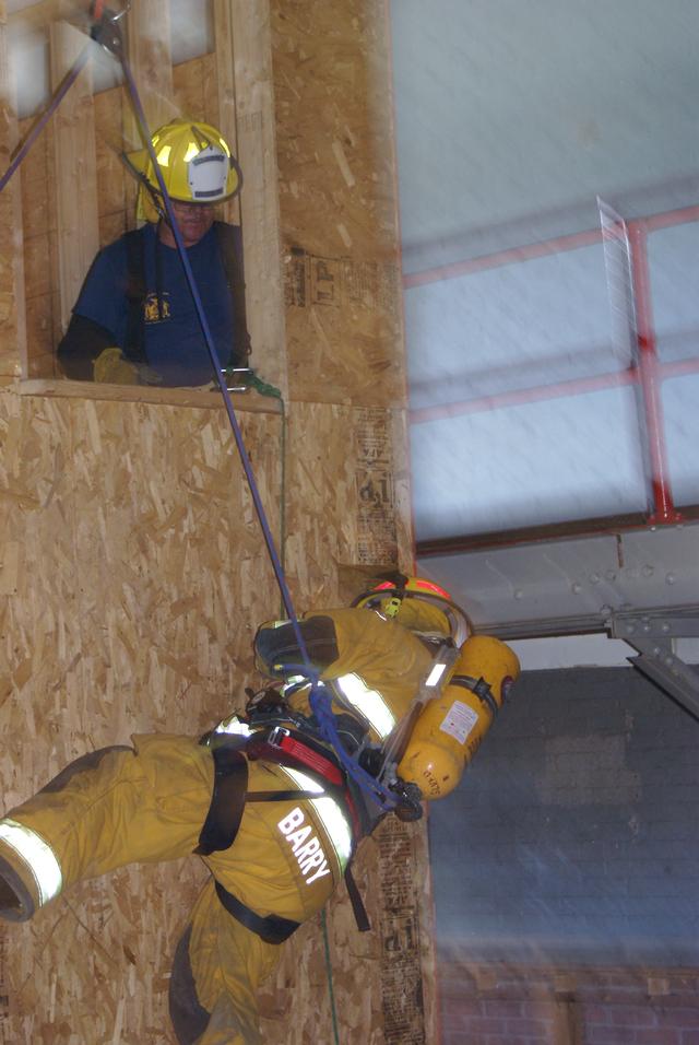 Craig Barry exits 2nd story window using bail out rope during New York State Firefighter Survival course in Willsboro NY 9/25/2010